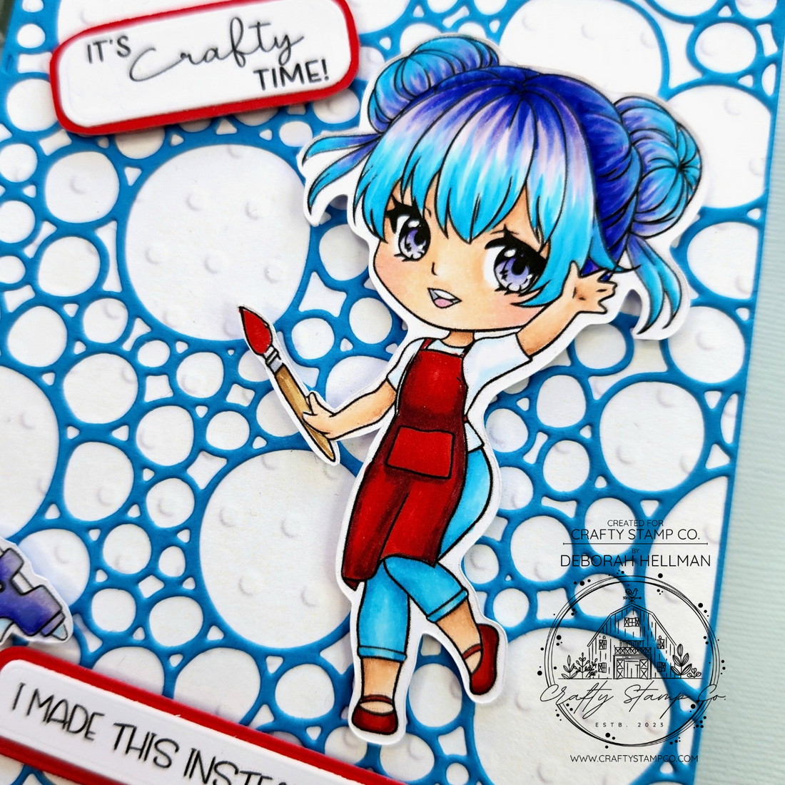 Handmade card by Deborah Hellman featuring a blue bubble background, a brightly colored Crafty Friends character holding a paintbrush, and sentiments that say “It’s Crafty Time” and “I made this instead of cleaning