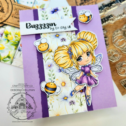 Handmade spring card by Deborah Hellman featuring Buzzy Bee Meadow with blonde hair, purple dress, and tiny bee accents layered over floral patterned paper.