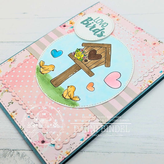 Handmade “Love Birds” card by Danni Bindel featuring a stamped birdhouse scene from the Love Is in the Air stamp set, layered over pink floral and polka dot papers from the Spring Is in the Air 6x6 paper pad.