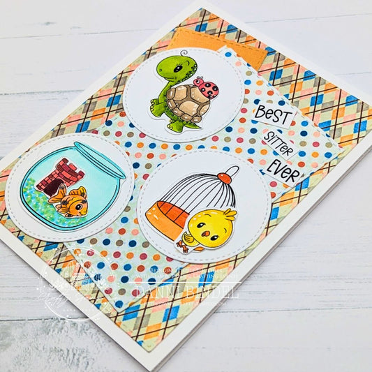 Handmade “Best Sitter Ever” card featuring a turtle, goldfish, and chick in stitched circle windows layered over colorful plaid and polka dot papers from the Fur Babies 6x6 pattern paper by Danni for Crafty Stamp Co.