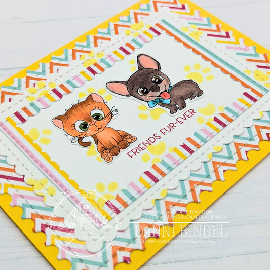 Handmade ‘Friends Fur-Ever’ card by Danni Bindel featuring orange cat and brown pup from the March 2026 Crafty Crew Kit, framed with bright chevron and striped layers.