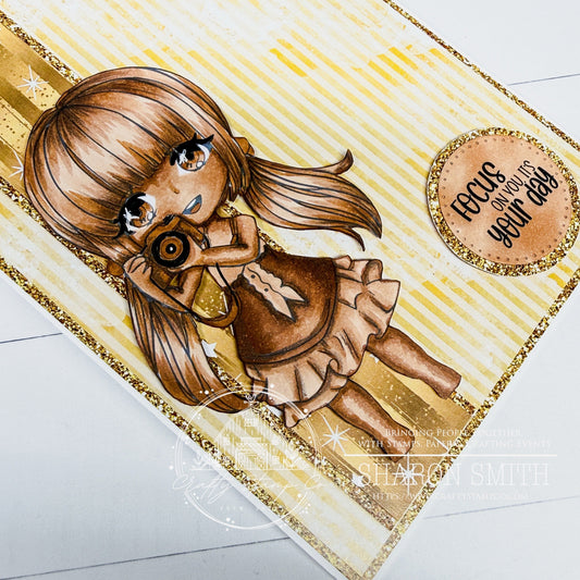 Handmade monochromatic birthday card in warm brown and gold tones featuring the Say Cheese Meadow girl holding a camera, with striped and star pattern papers and the sentiment “Focus on you, it’s your day,” designed by Sharon Smith for Crafty Stamp Co.