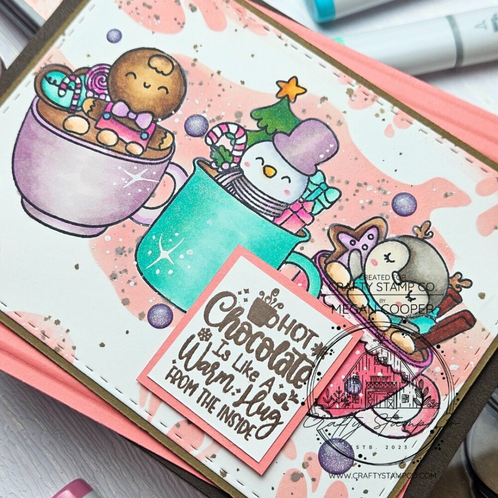 Handmade winter card featuring cute character mugs, pastel ink blending, stamped sentiment, and ink splat stencil background using Hot Cocoa Cups stamp set.