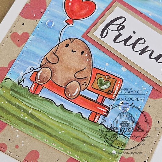 Handmade friendship card featuring Tate holding a heart balloon, layered sentiments, and a blue sky and grass scene with a heart-stenciled background, created by Megan Cooper for Crafty Stamp Co.